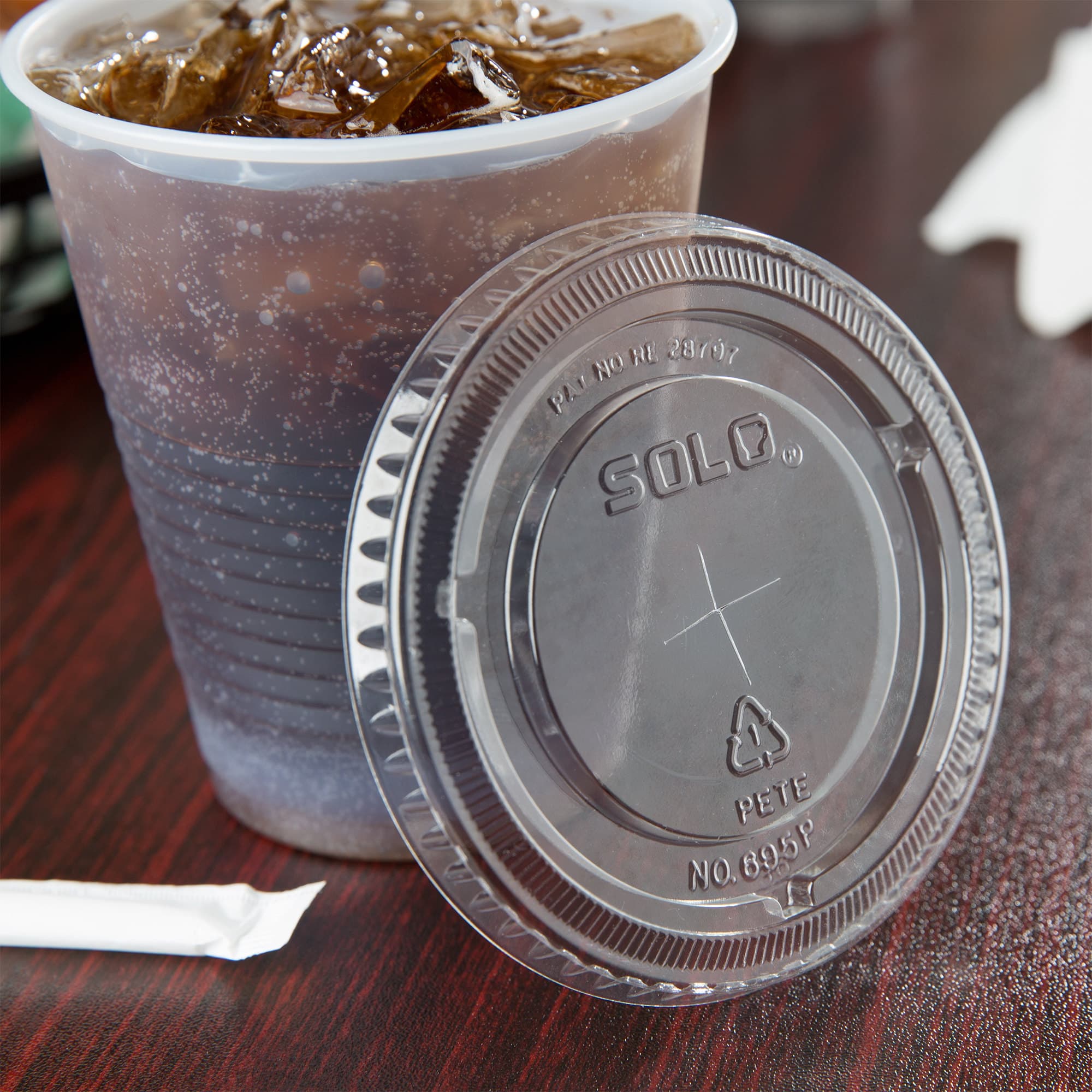 Solo 695TS Clear PET Lid for 12 and 14 oz. Containers with Straw Slot - Image 1